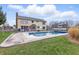 Backyard view of a pool area with a sunny lawn, patio, and the house in the background at 8414 Anchorage Ct, Indianapolis, IN 46236
