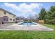 Relaxing backyard pool area perfect for entertaining, complemented by the surrounding greenery and clear blue sky at 8414 Anchorage Ct, Indianapolis, IN 46236