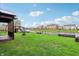 Expansive backyard with a playset, pond view, and ample space for outdoor activities at 8650 N Springview Dr, McCordsville, IN 46055