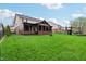 Spacious backyard with a covered patio and lush green grass, perfect for outdoor activities and enjoyment at 8650 N Springview Dr, McCordsville, IN 46055