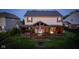 Evening shot of backyard featuring covered patio and an American flag, highlighting outdoor living at 8650 N Springview Dr, McCordsville, IN 46055