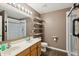 Bathroom with double sinks, shelves, shower and toilet at 8650 N Springview Dr, McCordsville, IN 46055