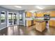 Well-lit kitchen featuring wood cabinets, island, stainless steel appliances, and access to the patio at 8650 N Springview Dr, McCordsville, IN 46055