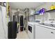 Practical utility room with a water heater, water softener, washer, and dryer for convenience at 8650 N Springview Dr, McCordsville, IN 46055