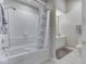 Bright bathroom with a shower-tub combo, white tile, and a neutral-toned vanity at 871 Gazebo Way, Greenwood, IN 46142