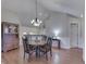 Dining room with wooden table, decorative chandelier, and hardwood flooring at 871 Gazebo Way, Greenwood, IN 46142