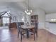 Open dining room adjacent to a modern kitchen with an adjacent living room and fireplace at 871 Gazebo Way, Greenwood, IN 46142