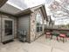 Stone-accented exterior with a patio area, complete with seating and a convenient access door at 871 Gazebo Way, Greenwood, IN 46142