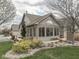 Rear exterior showcasing well-maintained landscaping and a sunroom addition with abundant natural light at 871 Gazebo Way, Greenwood, IN 46142