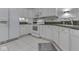 Bright kitchen features white cabinets, tile flooring, and modern appliances at 871 Gazebo Way, Greenwood, IN 46142