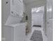 Laundry room features a stacked washer and dryer unit and utility sink at 871 Gazebo Way, Greenwood, IN 46142