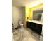 Bright bathroom features a double sink vanity, tiled floor, and stylish lighting fixtures at 9454 Tanhurst Dr, Indianapolis, IN 46250