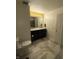 Bright bathroom features a double sink vanity, tiled floor, and stylish lighting fixtures at 9454 Tanhurst Dr, Indianapolis, IN 46250