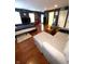Hardwood bedroom with a bed, sofa, and shelving, offering a modern living space at 9454 Tanhurst Dr, Indianapolis, IN 46250