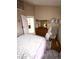 Bright bedroom with a dresser and mirror, featuring a comfy chair, offering a tranquil retreat within the home at 9454 Tanhurst Dr, Indianapolis, IN 46250