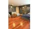 Bedroom featuring a hardwood floor, sofa, bed, and accent wall with modern decor at 9454 Tanhurst Dr, Indianapolis, IN 46250