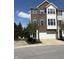 Charming brick townhome featuring a two-car garage and beautiful blue shutters at 9454 Tanhurst Dr, Indianapolis, IN 46250