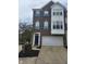 Charming brick townhouse with blue shutters and a two-car garage at 9454 Tanhurst Dr, Indianapolis, IN 46250