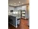 Spacious kitchen with gray cabinets, granite countertops, and stainless steel appliances at 9454 Tanhurst Dr, Indianapolis, IN 46250