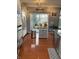 Kitchen with gray cabinets, stainless appliances, and island with hardwood flooring at 9454 Tanhurst Dr, Indianapolis, IN 46250