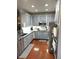 Updated kitchen with gray cabinets, stainless steel appliances and hardwood floors at 9454 Tanhurst Dr, Indianapolis, IN 46250