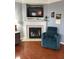 Comfortable living room with a fireplace, TV, and cozy armchair at 9454 Tanhurst Dr, Indianapolis, IN 46250