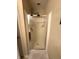 Bathroom featuring a tiled shower with glass door and chrome hardware in neutral colored bathroom at 9454 Tanhurst Dr, Indianapolis, IN 46250