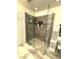 Modern shower features clear glass, decorative tiling, and built-in storage shelves at 9454 Tanhurst Dr, Indianapolis, IN 46250
