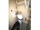 A water softener and plumbing are featured in this utility area with concrete flooring at 9454 Tanhurst Dr, Indianapolis, IN 46250