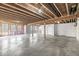 Unfinished basement with exposed beams, concrete floor, and access to an outdoor space at 11172 Cliffside Dr, Fortville, IN 46040