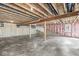 Unfinished basement with exposed beams, concrete floor, and access to an outdoor space at 11172 Cliffside Dr, Fortville, IN 46040