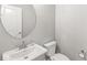 Powder room features a pedestal sink and a round mirror at 11172 Cliffside Dr, Fortville, IN 46040