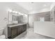 Modern bathroom featuring a granite countertop, dual sinks, and a tiled walk-in shower at 11172 Cliffside Dr, Fortville, IN 46040