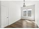 Bright room with hardwood floors, two windows, and a decorative chandelier at 11172 Cliffside Dr, Fortville, IN 46040