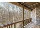 Wooden deck with stone detailing and a view of the surrounding wooded area at 11172 Cliffside Dr, Fortville, IN 46040