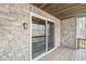 Stone patio leads to a wooden deck with screened door leading to backyard at 11172 Cliffside Dr, Fortville, IN 46040
