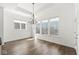 Dining room with hardwood floors, a chandelier and three large windows at 11172 Cliffside Dr, Fortville, IN 46040