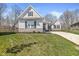 Beautifully landscaped home with a stone foundation, an attached garage, and manicured green grass at 11172 Cliffside Dr, Fortville, IN 46040