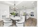 Open kitchen and dining room combo with hardwood floors and stainless steel appliances at 11172 Cliffside Dr, Fortville, IN 46040
