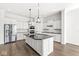 Bright kitchen featuring a large island, stainless steel appliances, and white cabinetry at 11172 Cliffside Dr, Fortville, IN 46040