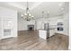Open kitchen and living room combo with hardwood floors and stainless steel appliances at 11172 Cliffside Dr, Fortville, IN 46040