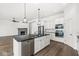 Kitchen with a center island, stone fireplace in the living room, and stainless steel appliances at 11172 Cliffside Dr, Fortville, IN 46040