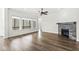 Spacious living room with hardwood floors, a cozy fireplace, and large windows overlooking a serene view at 11172 Cliffside Dr, Fortville, IN 46040