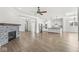 Spacious living room with fireplace, hardwood floors, and kitchen view, designed for entertaining and relaxation at 11172 Cliffside Dr, Fortville, IN 46040