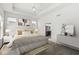 Well-lit bedroom with tray ceiling, neutral decor, hardwood floors, and attached ensuite at 11172 Cliffside Dr, Fortville, IN 46040
