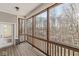 View of the wooded scenery from the screened-in porch, featuring natural wood elements at 11172 Cliffside Dr, Fortville, IN 46040