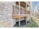 View of the porch with wood rails and a stone foundation at 11172 Cliffside Dr, Fortville, IN 46040