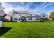 Lush backyard featuring a well-manicured lawn, complemented by the home's exterior and blue skies at 1228 Knapps Ct, Greenwood, IN 46142