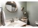 Bathroom with a framed mirror, light green walls, and woven baskets for storage at 1228 Knapps Ct, Greenwood, IN 46142