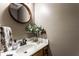 Well-lit powder room showcasing a wooden framed mirror, a sink with nice faucet, and neutral paint at 1228 Knapps Ct, Greenwood, IN 46142